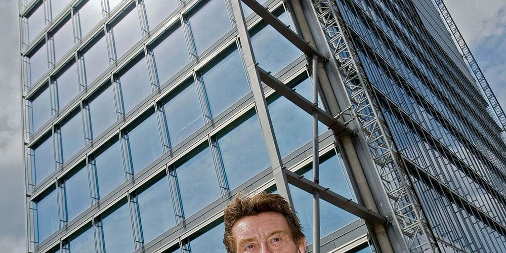 Das Bild zeigt den Architekten Helmut Jahn vor dem Weser Tower.