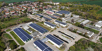 Das Bild zeigt die Gebäude mit den Solaranlagen der Agrargenossenschaften in Aschersleben aus der Luftansicht.